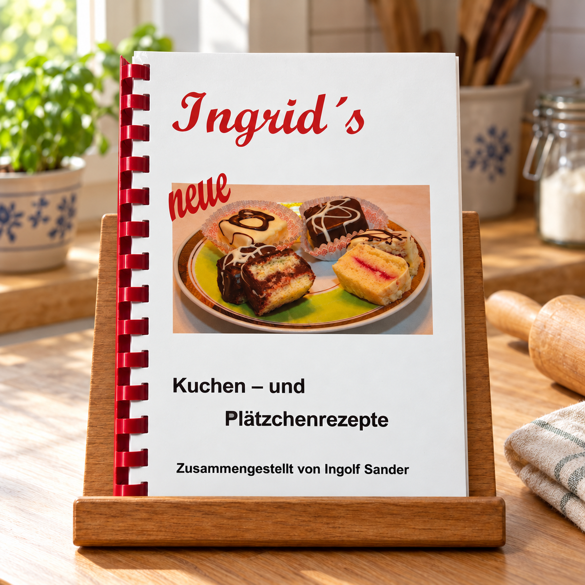 Ingrids neue Kuchen und Plätzchenrezepte auf einem hölzernen Buchständer in einer hellen Küche